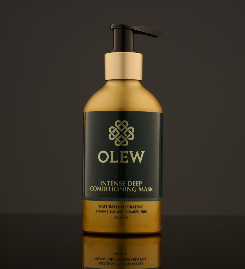 Olew, Intense Deep Conditioning Hair Mask, naturally hydrating vegan haircare which is SLS and Paraben Free comes in a gold and dark green bottle with a push pump on top. The image is on a dark grey background