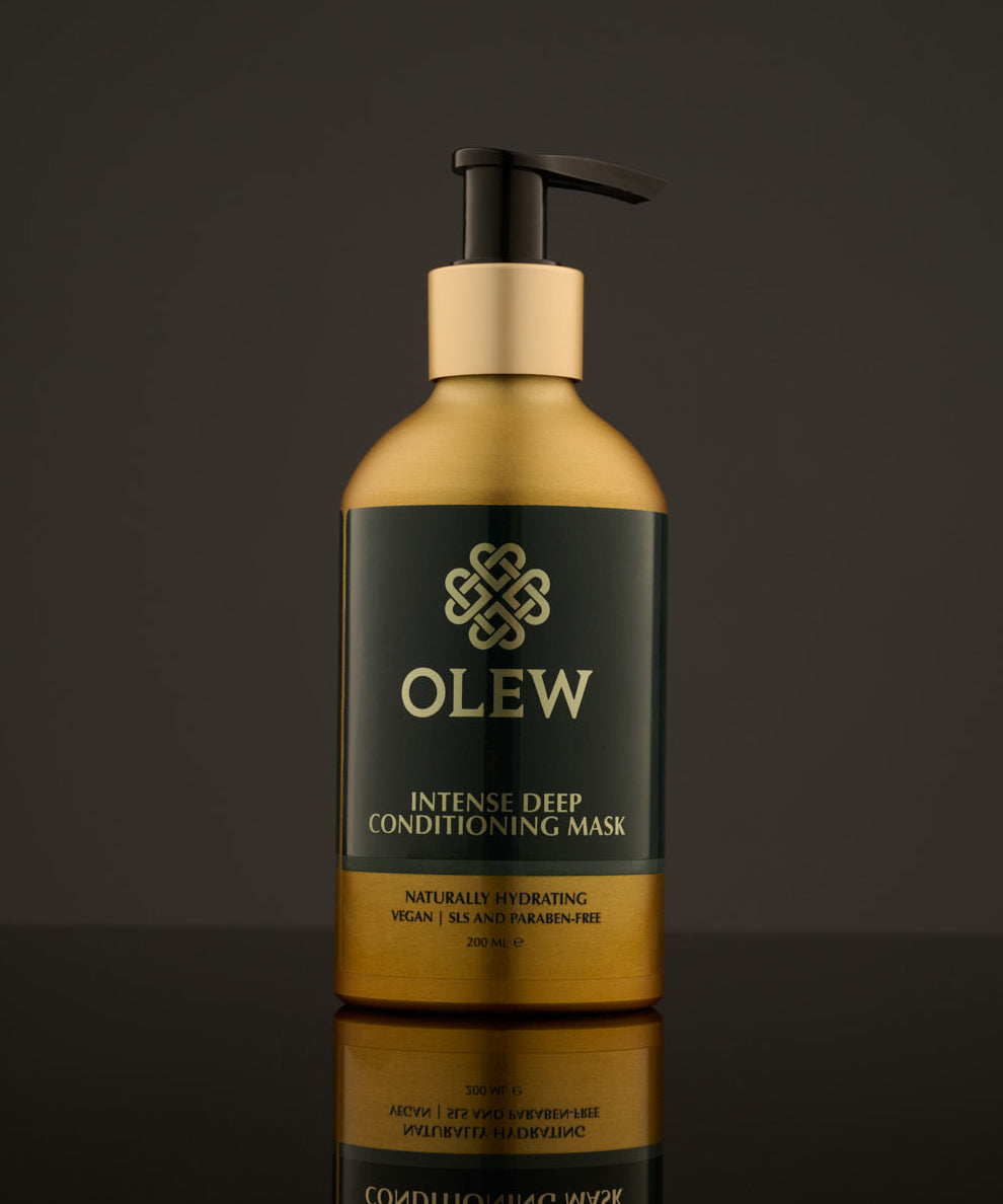 Olew, Intense Deep Conditioning Hair Mask, naturally hydrating vegan haircare which is SLS and Paraben Free comes in a gold and dark green bottle with a push pump on top. The image is on a dark grey background