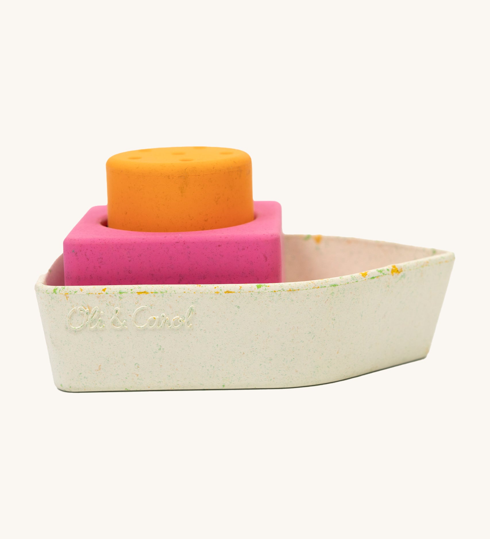 A closer look at the Oli & Carol Boat Bath Toy - Orange, from the side on a cream background. The boat has lots of small coloured pieces due to the material of the boat being upcycled