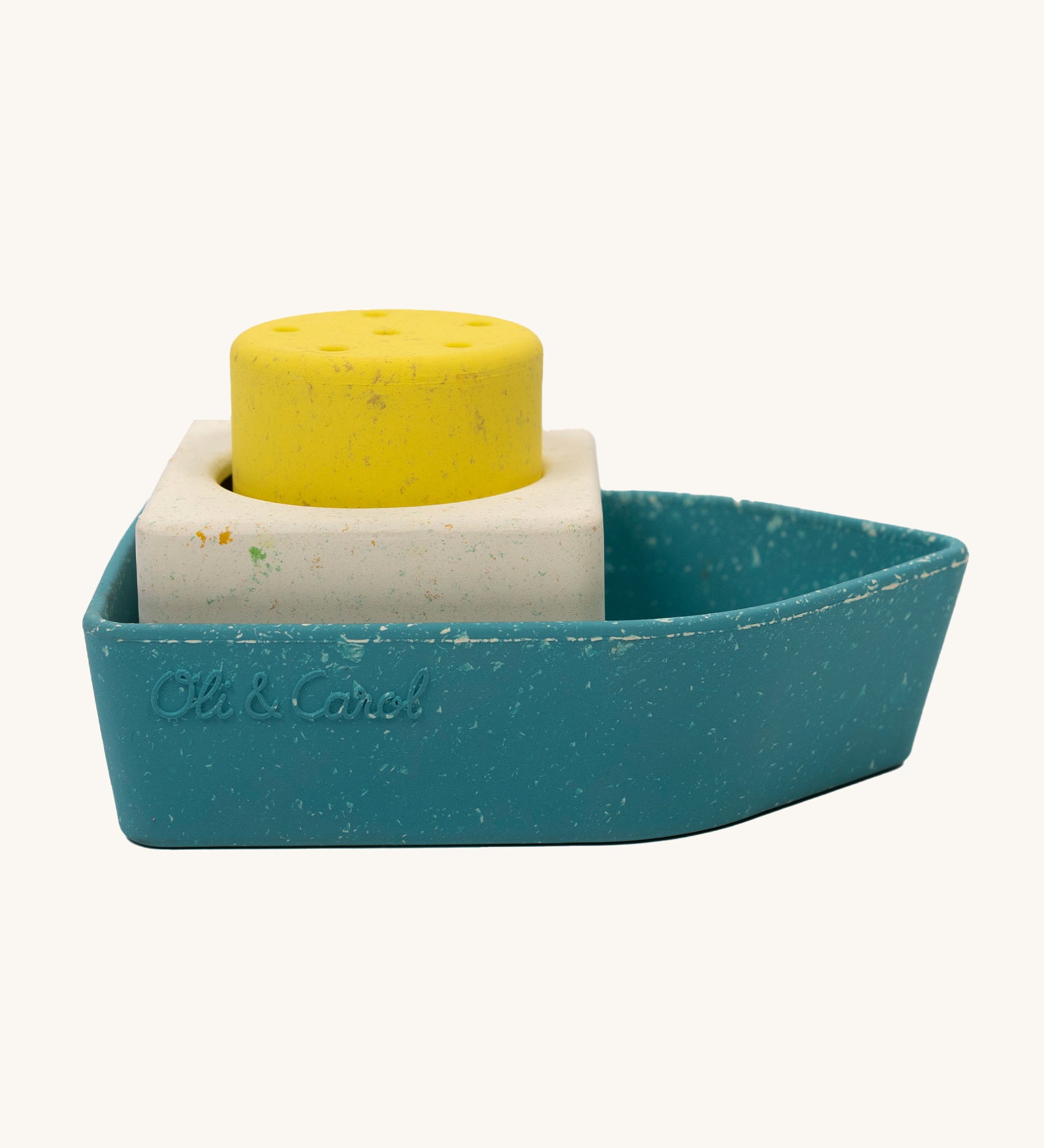 Oli &amp; Carol Boat Bath Toy - 100% Upcycled Natural Rubber on a cream background. The boat has different coloured pieces in yellow, white and blue.