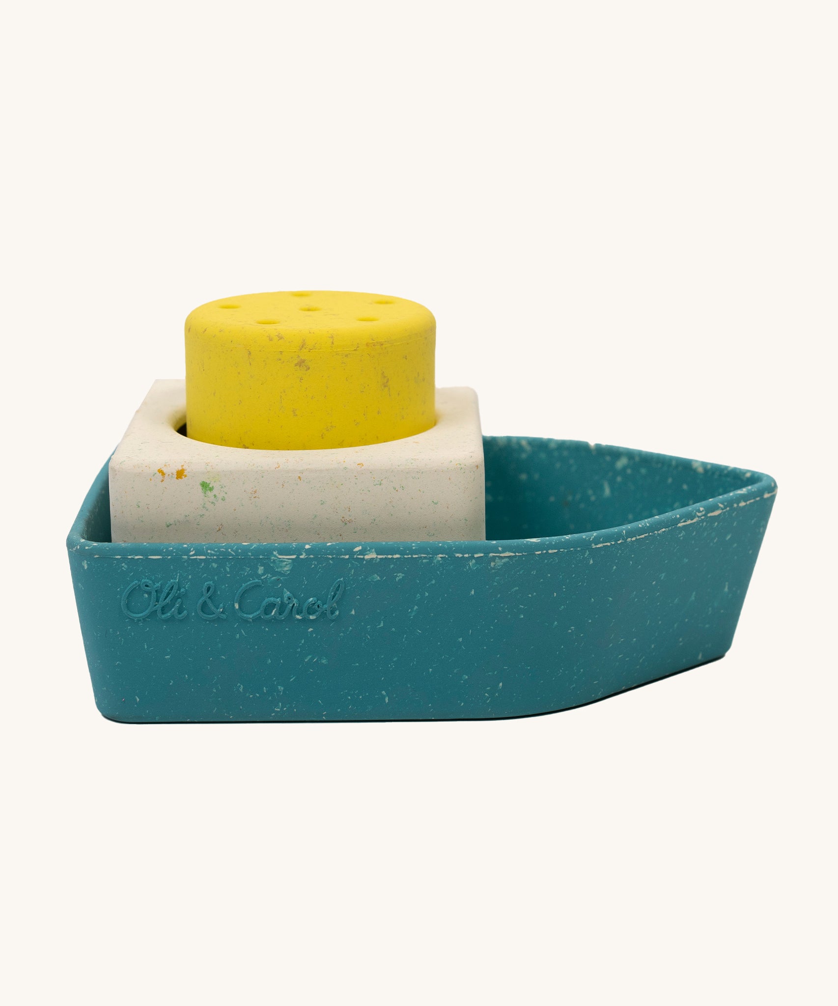 Oli &amp; Carol Boat Bath Toy - 100% Upcycled Natural Rubber on a cream background. The boat has different coloured pieces in yellow, white and blue.