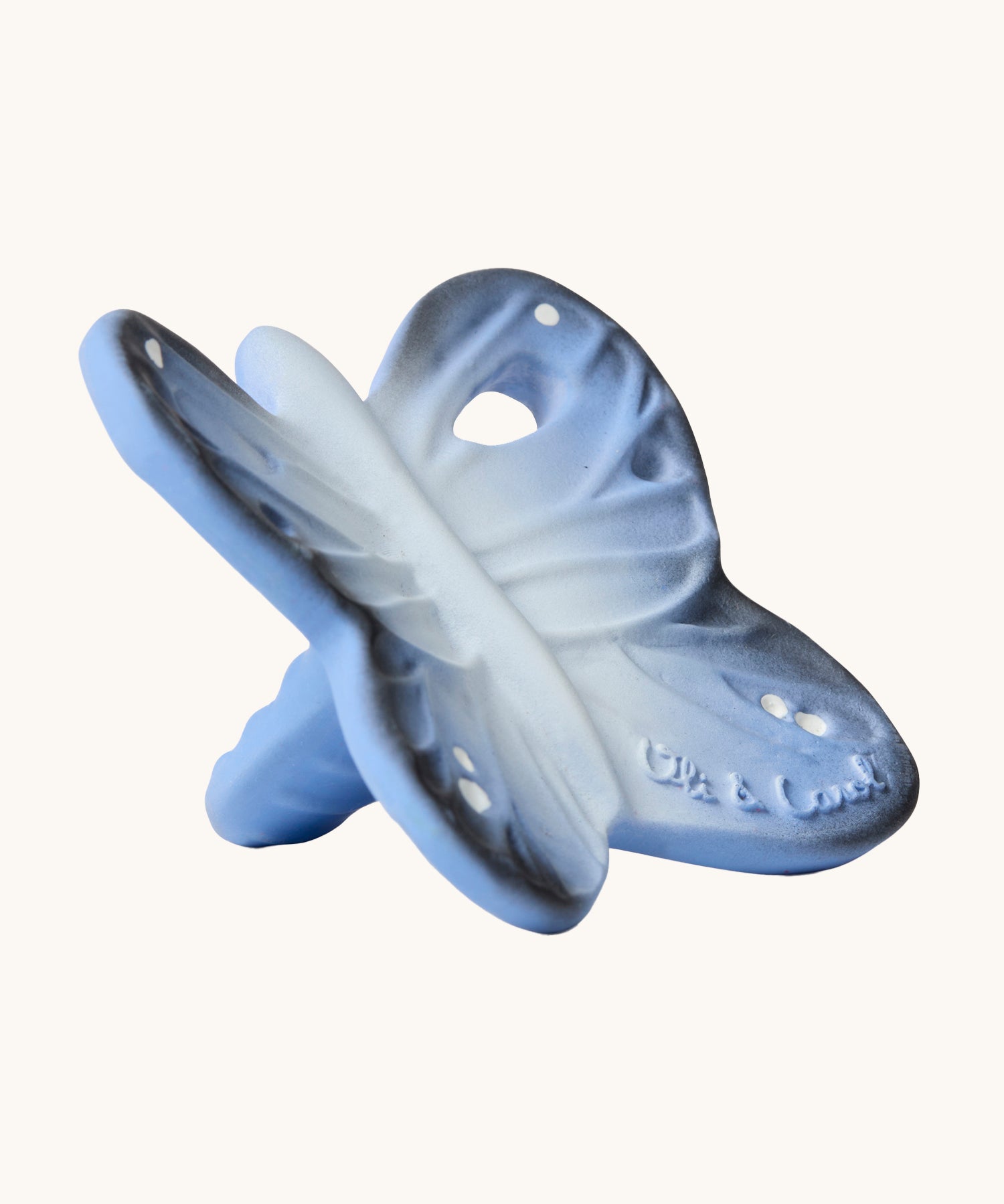 A side view of the Oli & Carol Natural Rubber Mini Teether - Blues The Butterfly, showing the texture of the teether