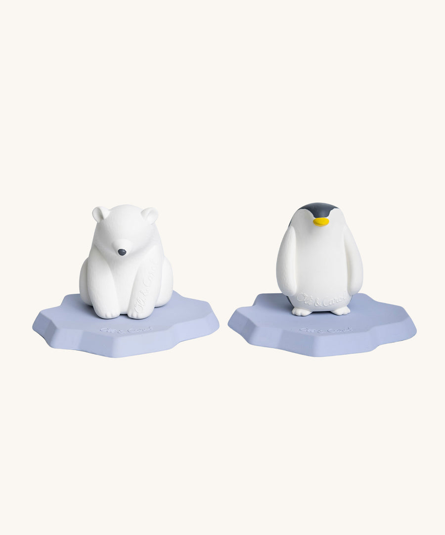 Oli & Carol Polar Bear and Penguin Bath Toy stood side by side. both Polar bear and Penguin are stood on their flat iceberg floating parts, on a cream background