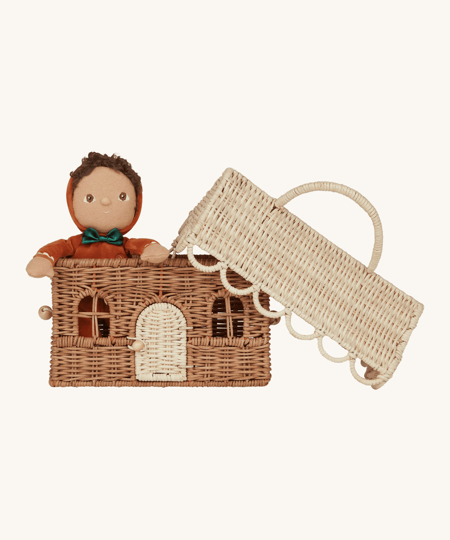 A Dinky Dinkum doll is inside the Olli Ella Rattan Gingerbread House Basket so give a size scale of how big the basket is. The lid is leaning on the top of the basket