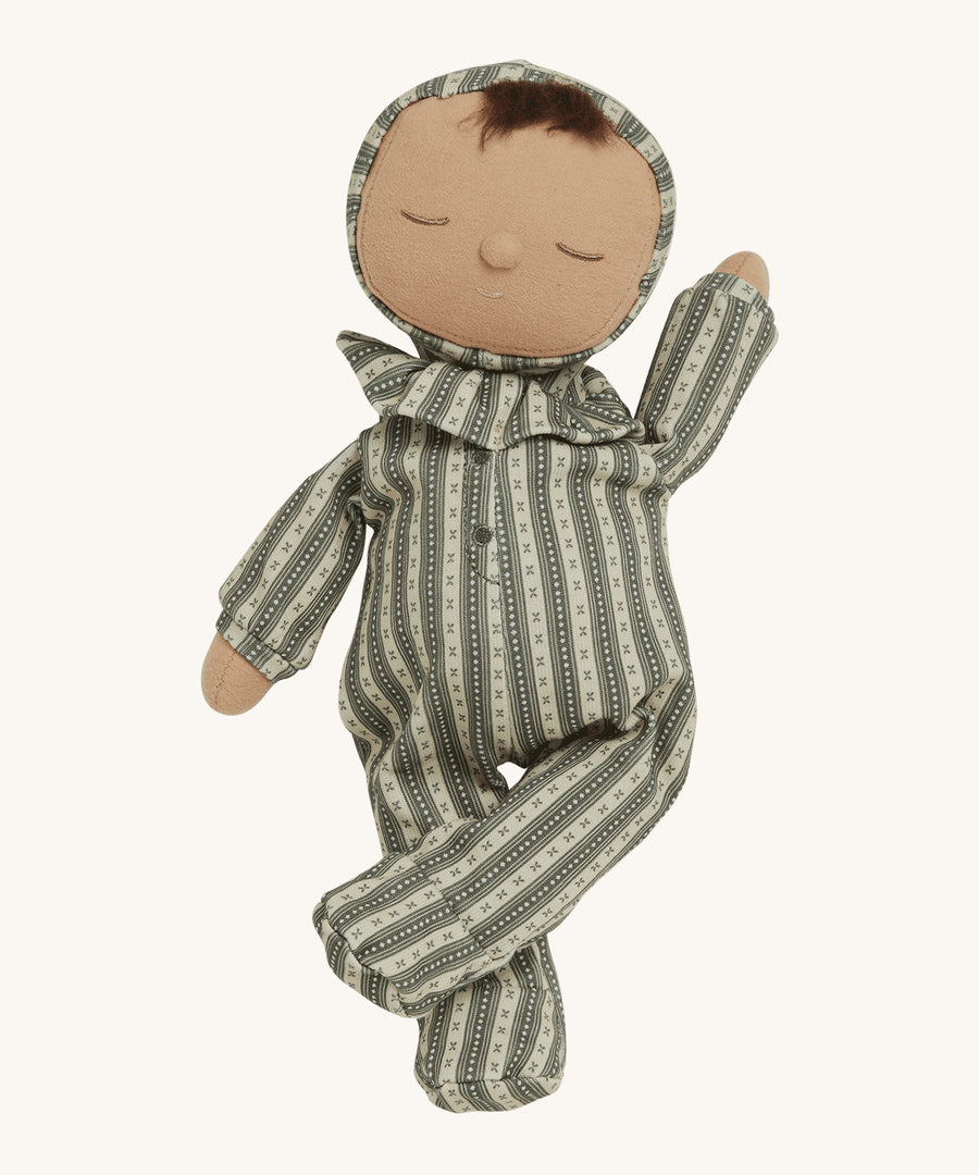 Olli Ella Dozy Dinkum Doll Pie - Clover, is a soft body kids doll toy, with a vintage style white and green stripe outfit and hood, with a frill collar. Pie has a warm, smiling, sleepy face, a cute button nose and a tuft of brown hair poking out from underneath its hood. On a cream background