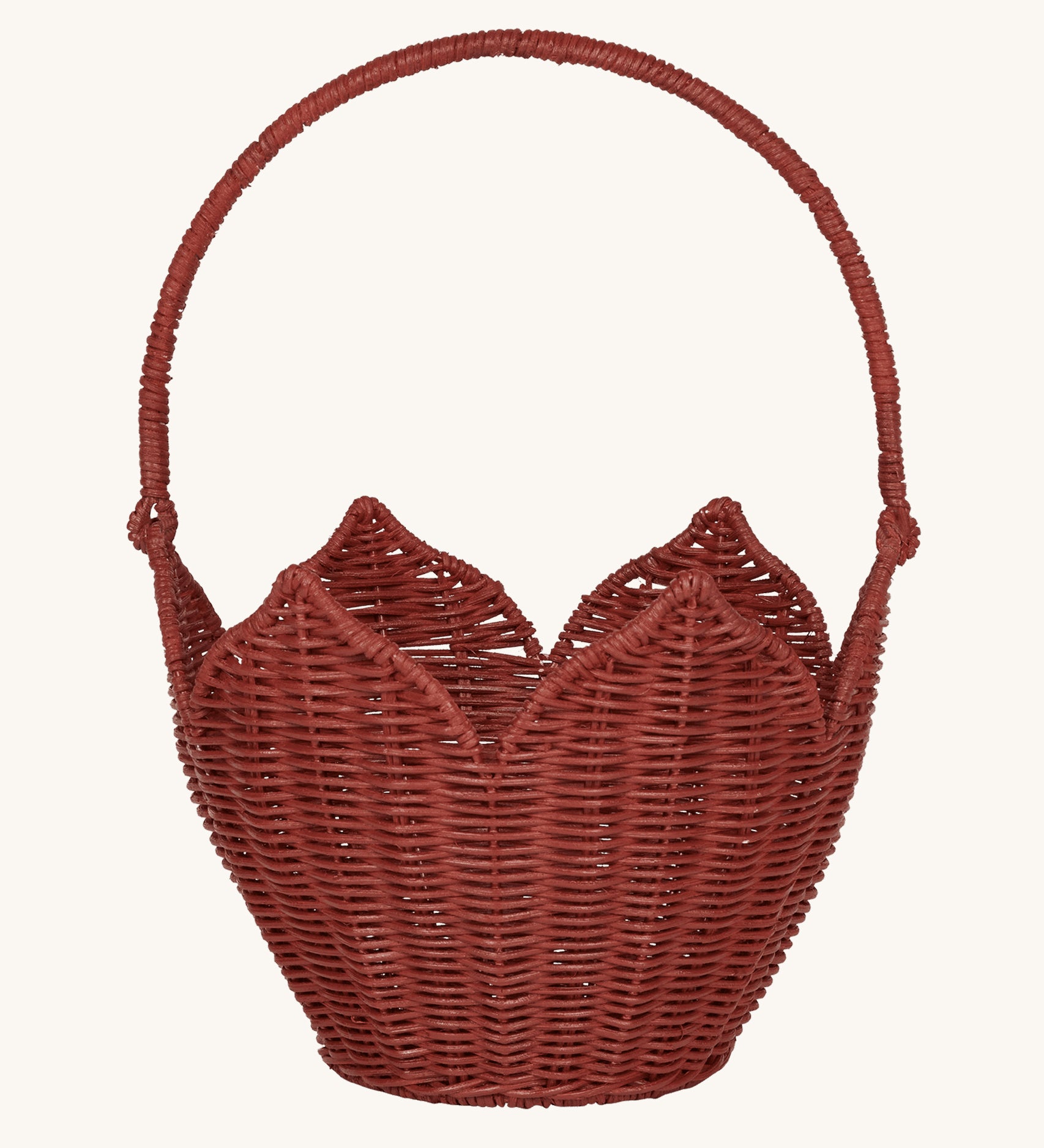 Olli Ella Rattan Poinsettia Carry Basket is a beautiful scalloped, handwoven, rattan basket in a poinsettia red colour, with a carry handle. The basket is on a cream background.