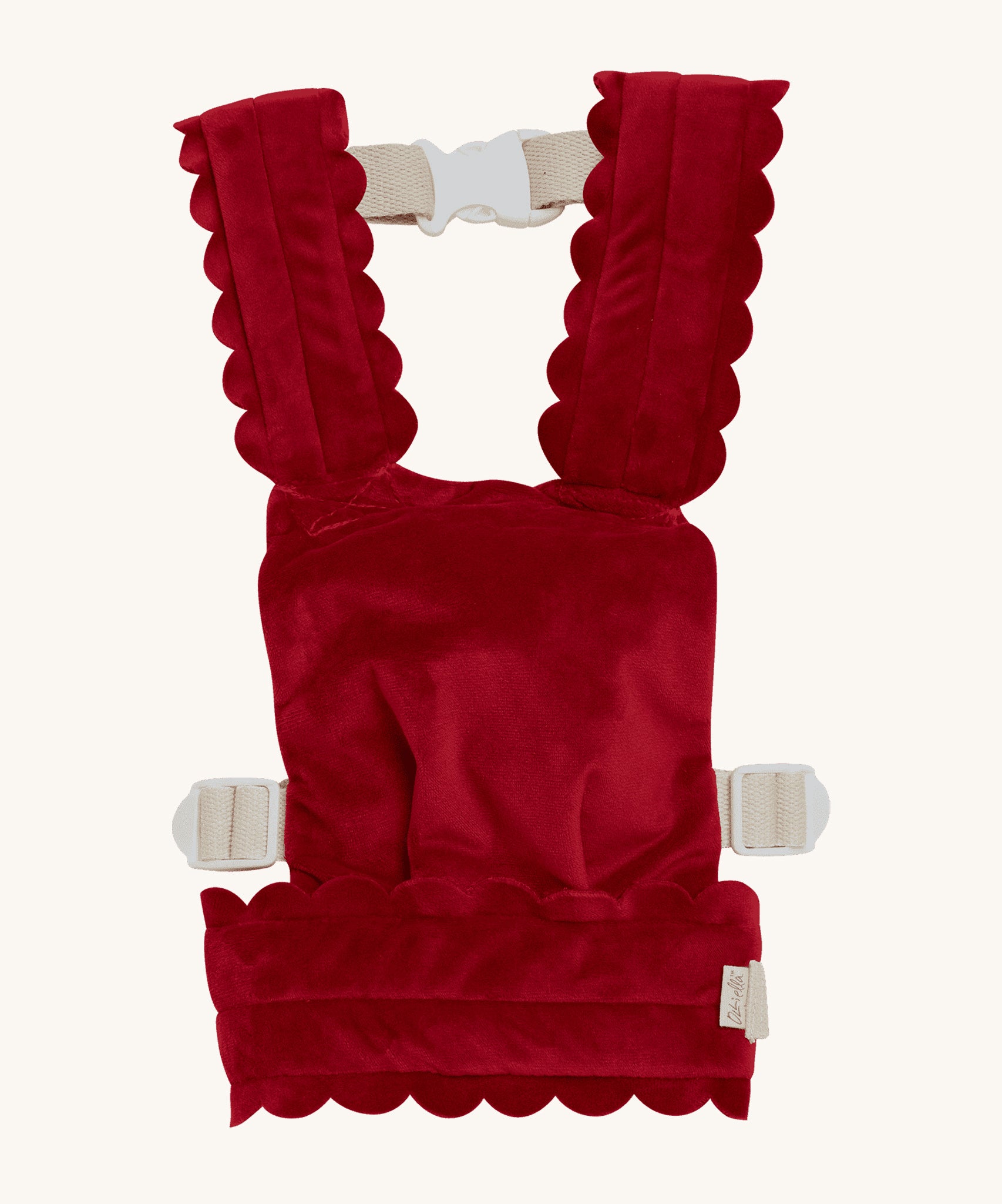 Olli Ella Dinkum Dolls Petal Carrier in Red Velvet, has scalloped petal shaped straps and waist band, adjustable straps and can be worn on the front and the back. The image is on a cream background