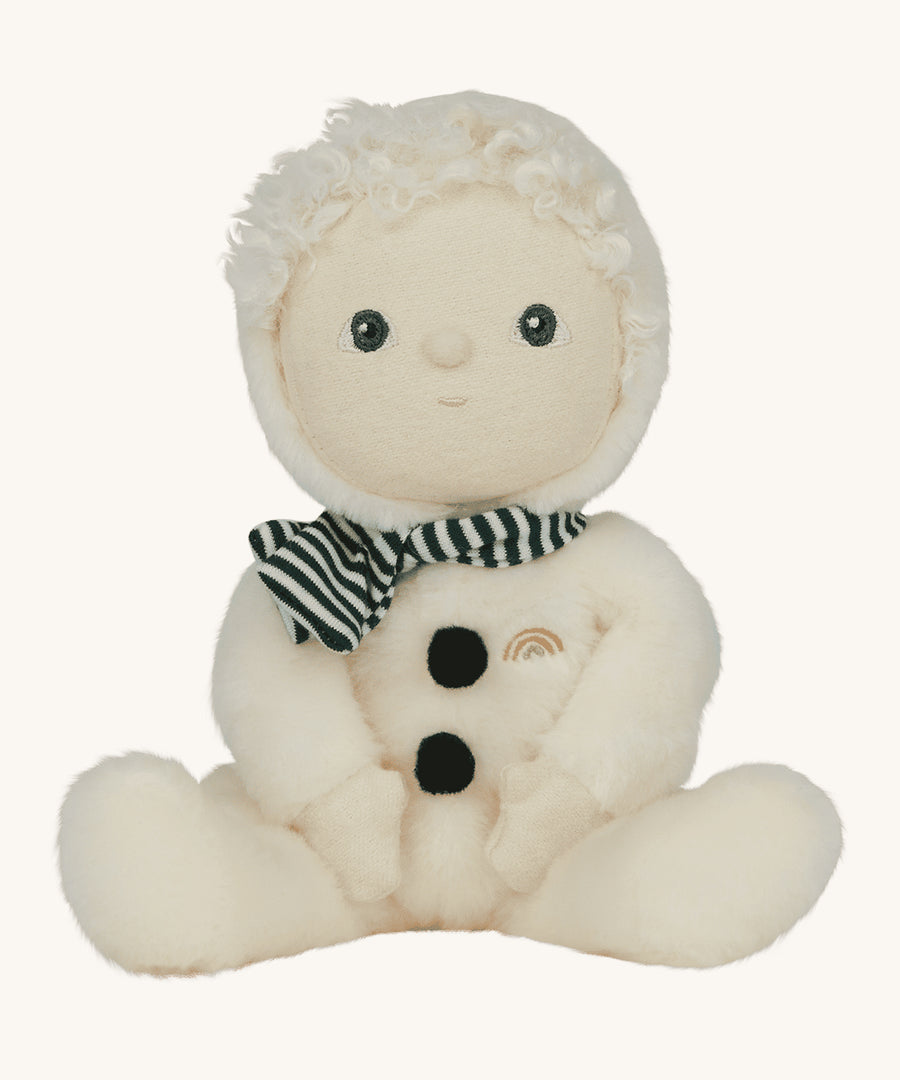 Olli Ella Dinky Dinkum Doll - Sidney Snowman is part of the festive, limited edition Jolly Dolly range from Olli Ella. Sidney wears a soft, white fluffy onsie with a moveable hood,  a green and white stripe scarf, white hair, white skin and two black pompom buttons to look like coal. The image is on a cream background