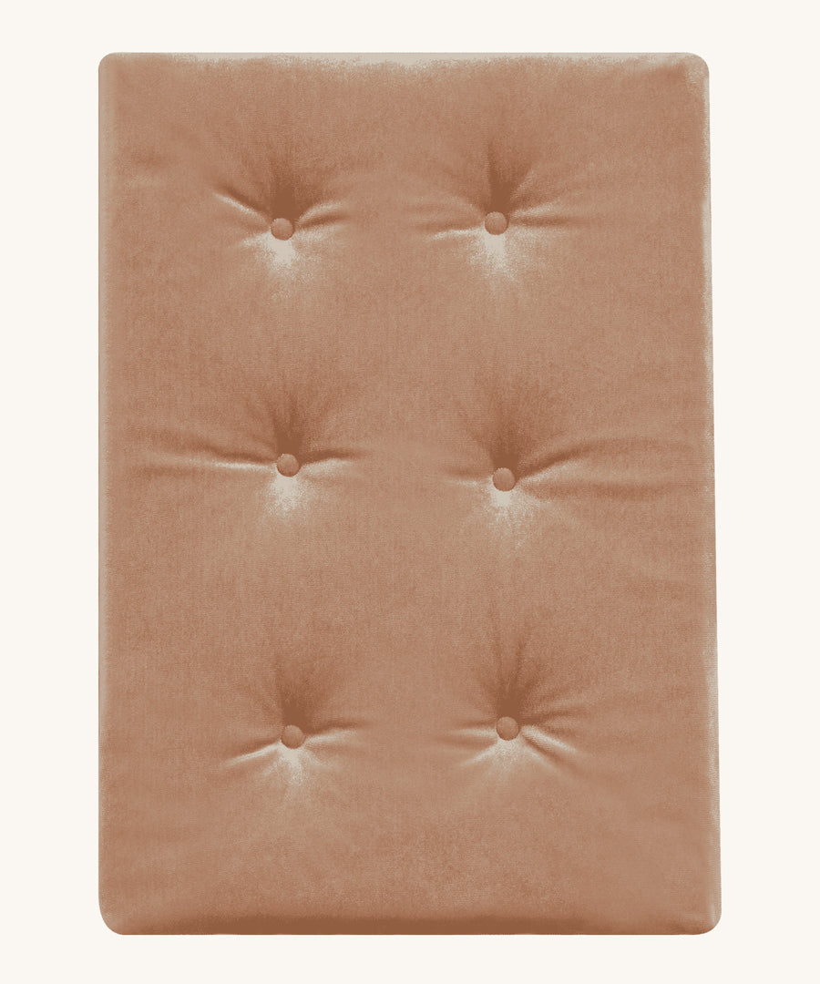 A soft, velvet Olli Ella Strolley mattress perfect for keeping any doll comfy in a Strolley. This mattress is in Champagne colour and is on a cream background