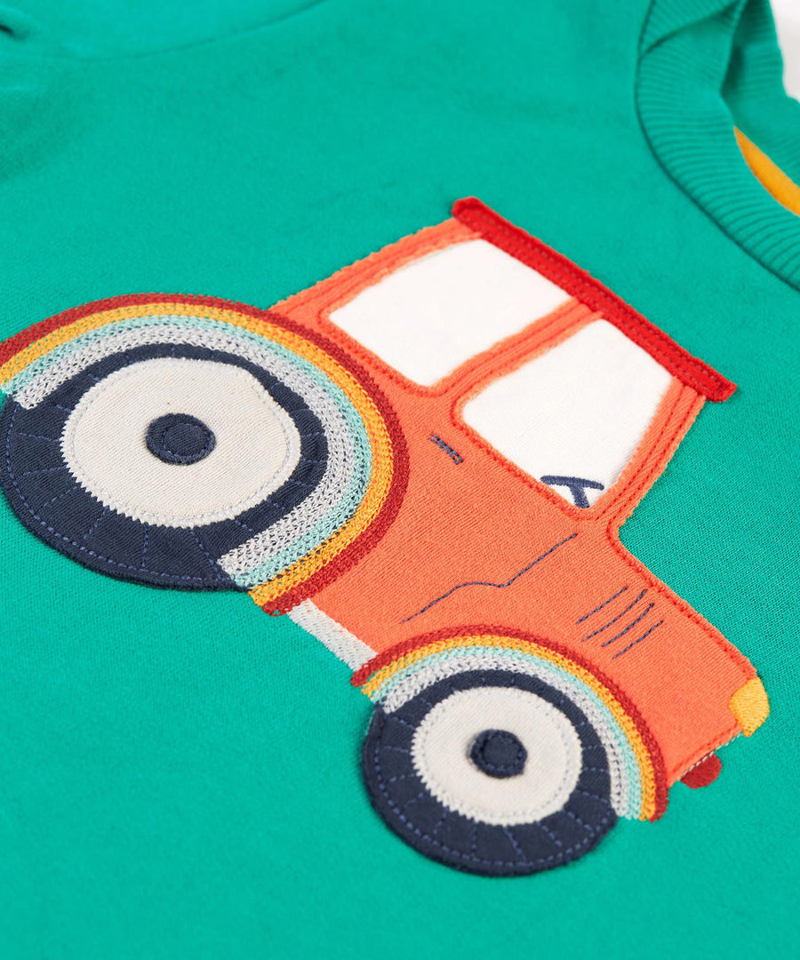 A closer look at the tractor applique on the Frugi Easy On Jumper - Iguana/Tractor