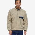 A person wearing the Patagonia Men's Synchilla Snap-T Fleece - Oatmeal Heather, showing the front of the fleece