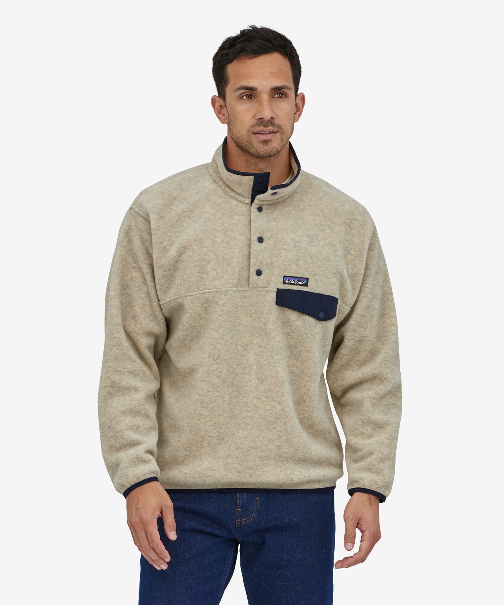 A person wearing the Patagonia Men's Synchilla Snap-T Fleece - Oatmeal Heather, showing the front of the fleece