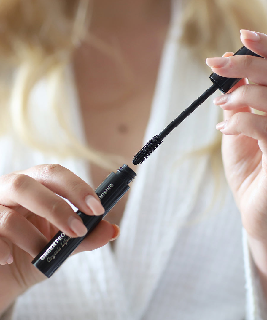 A person taking out the mascara wand from the Green People Volumising Mascara, and giving a closer view of the wand bristles 