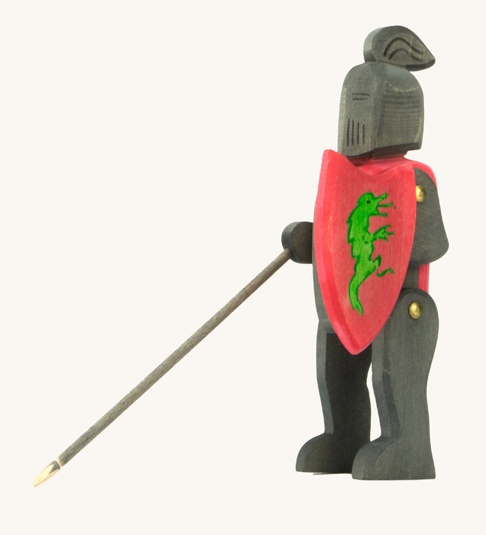 Ostheimer handmade and hand painted, wooden black knight. The knight holds a red shield with a green painted dragon on the front. This figure is also poseable with moving arms and legs.