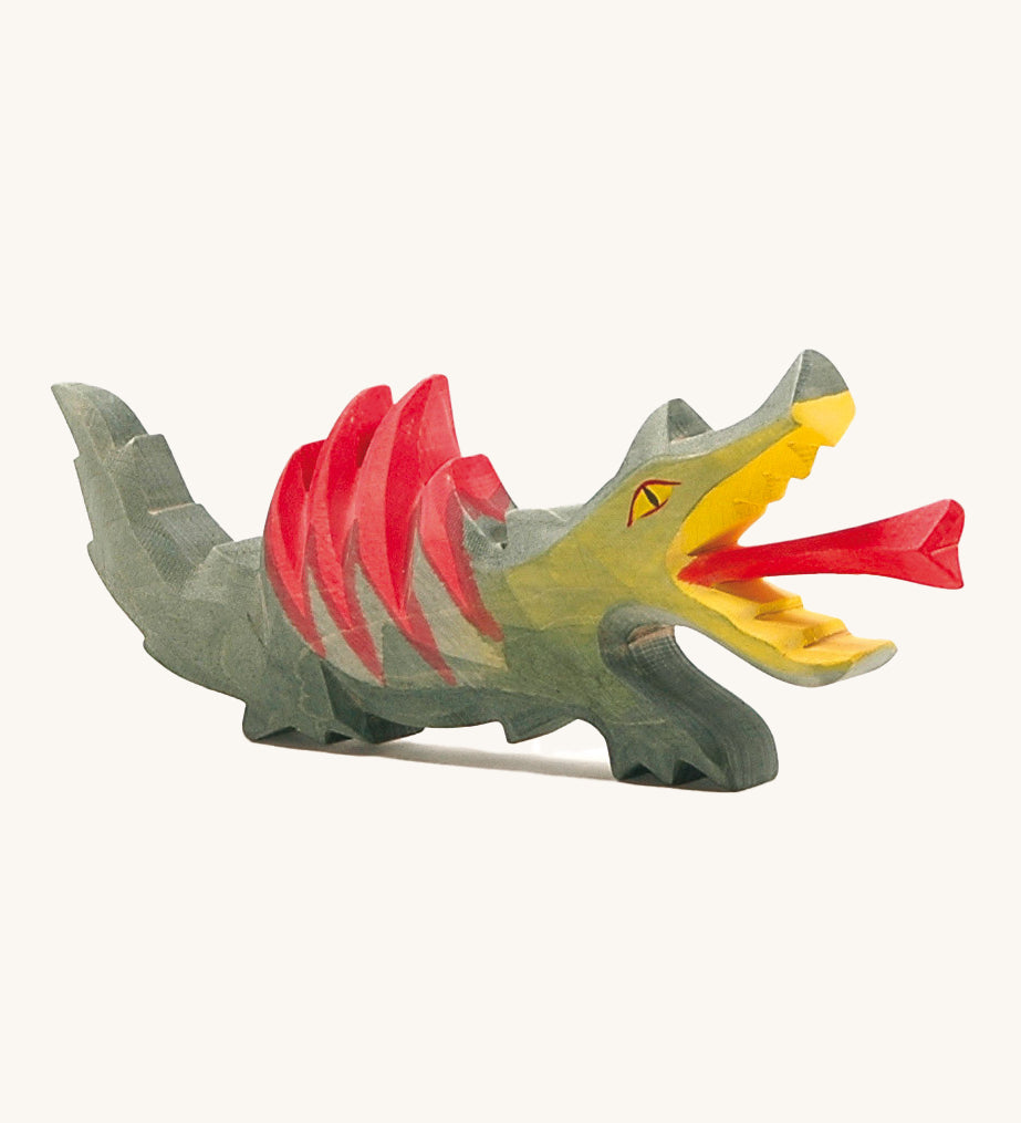 A fire-breathing Ostheimer dragon toy! With a green body, red spines on its back, a yellow mouth and a red frame shooting from it's mouth. Perfect for playing knights and castles!