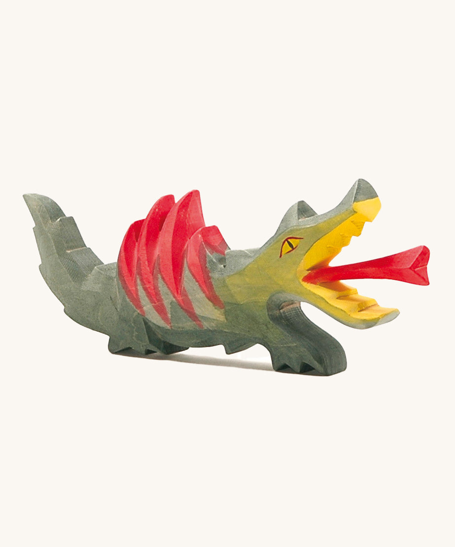 A fire-breathing Ostheimer dragon toy! With a green body, red spines on its back, a yellow mouth and a red frame shooting from it's mouth. Perfect for playing knights and castles!