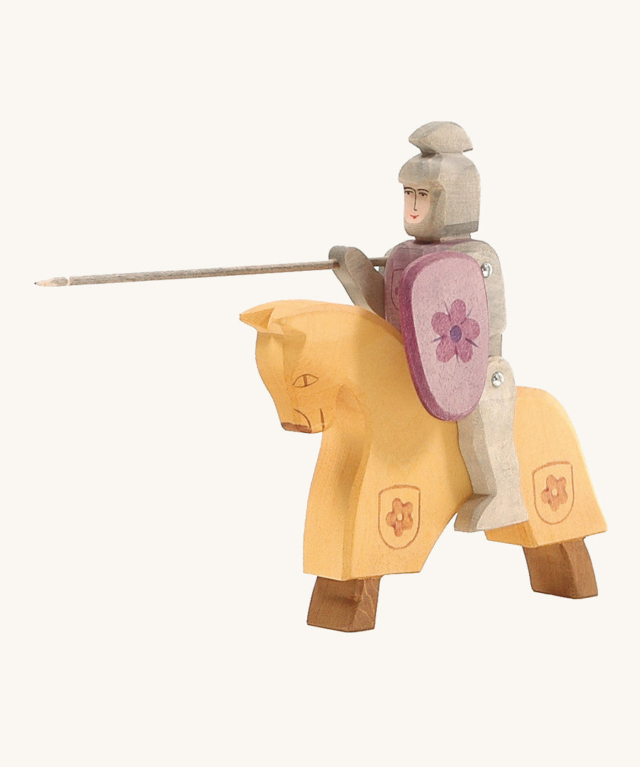 Ostheimer Red Riding Knight, riding into battle on their horse. The horse is yellow but is made to look like it's dressed in armour as it has a flower coat of arms on the bottom of the yellow section