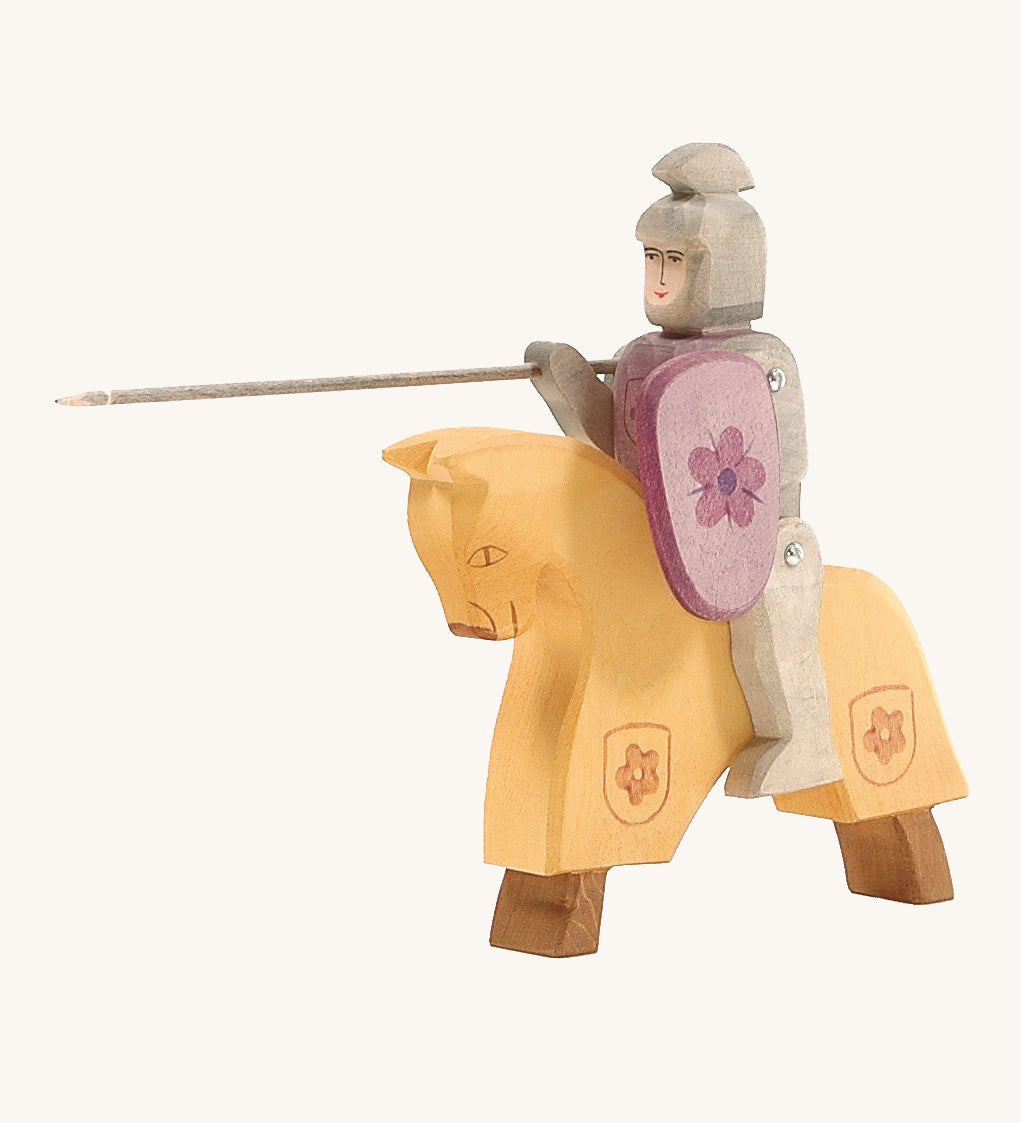 Ostheimer Red Riding Knight, riding into battle on their horse. The horse is yellow but is made to look like it's dressed in armour as it has a flower coat of arms on the bottom of the yellow section