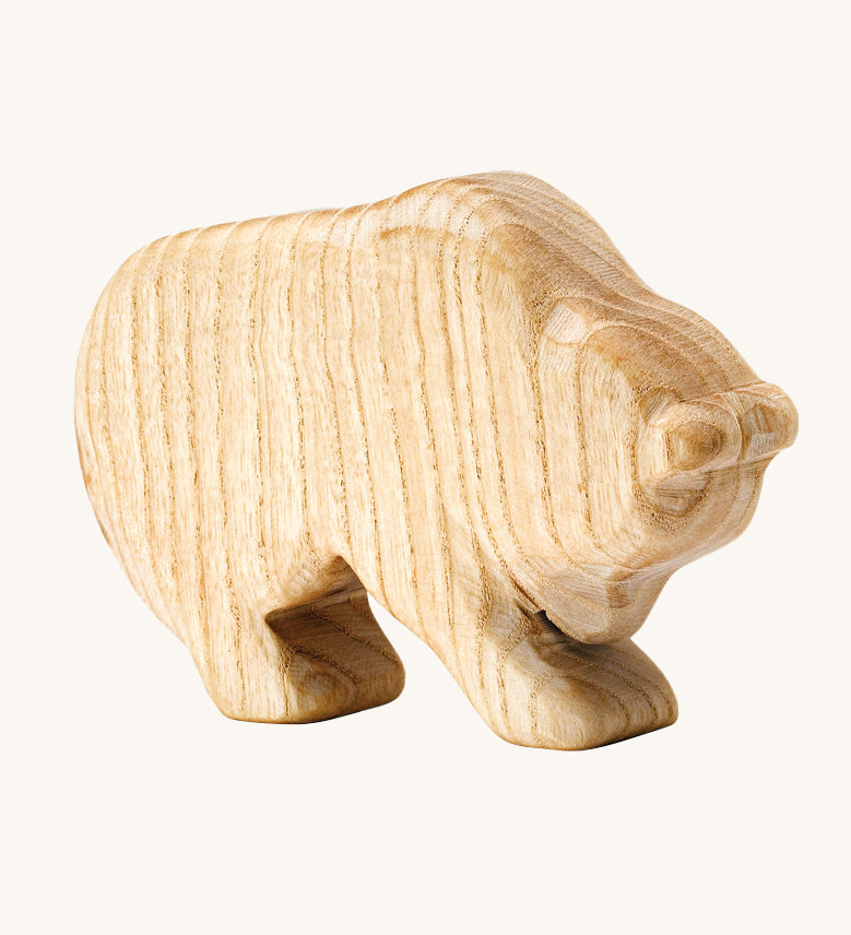 A beautiful, hand crafted bear figure showing the natural wood of the toy