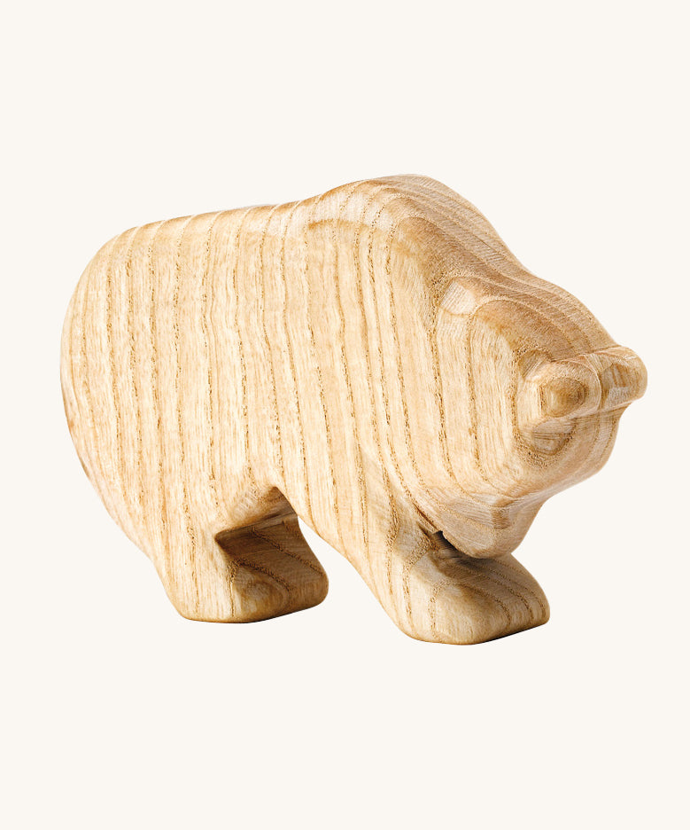 A beautiful, hand crafted bear figure showing the natural wood of the toy