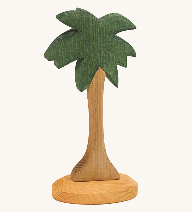 This palm tree has a slim natural wooden trunk and fronds stained dark green, with a light wooden base. Perfect for any beach or desert play scene