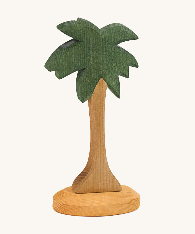 This palm tree has a slim natural wooden trunk and fronds stained dark green, with a light wooden base. Perfect for any beach or desert play scene