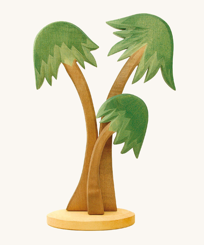 3 Ostheimer Palm Trees with a base support, with green leaves and light brown tree trunks. Set a nativity scene for Advent and Christmas or make your very own desert island with this group of three towering palm trees, swaying gently in the breeze