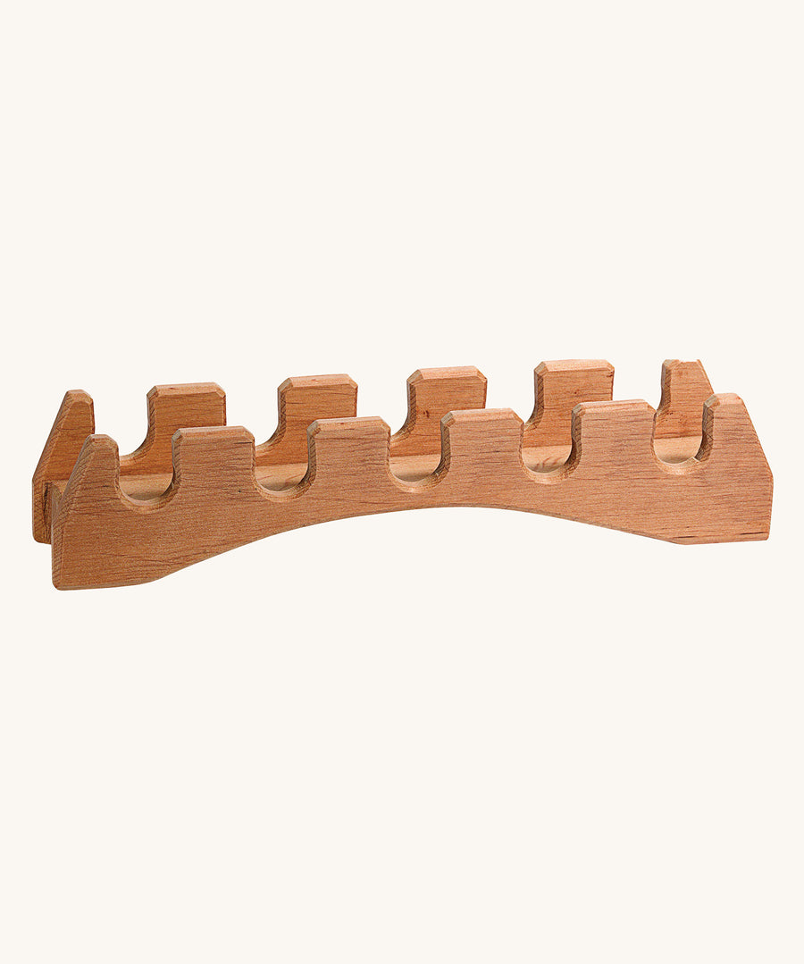 Ostheimer wooden castle toy bridge on a beige background. Hand made and showing the natural wood grain of the toy