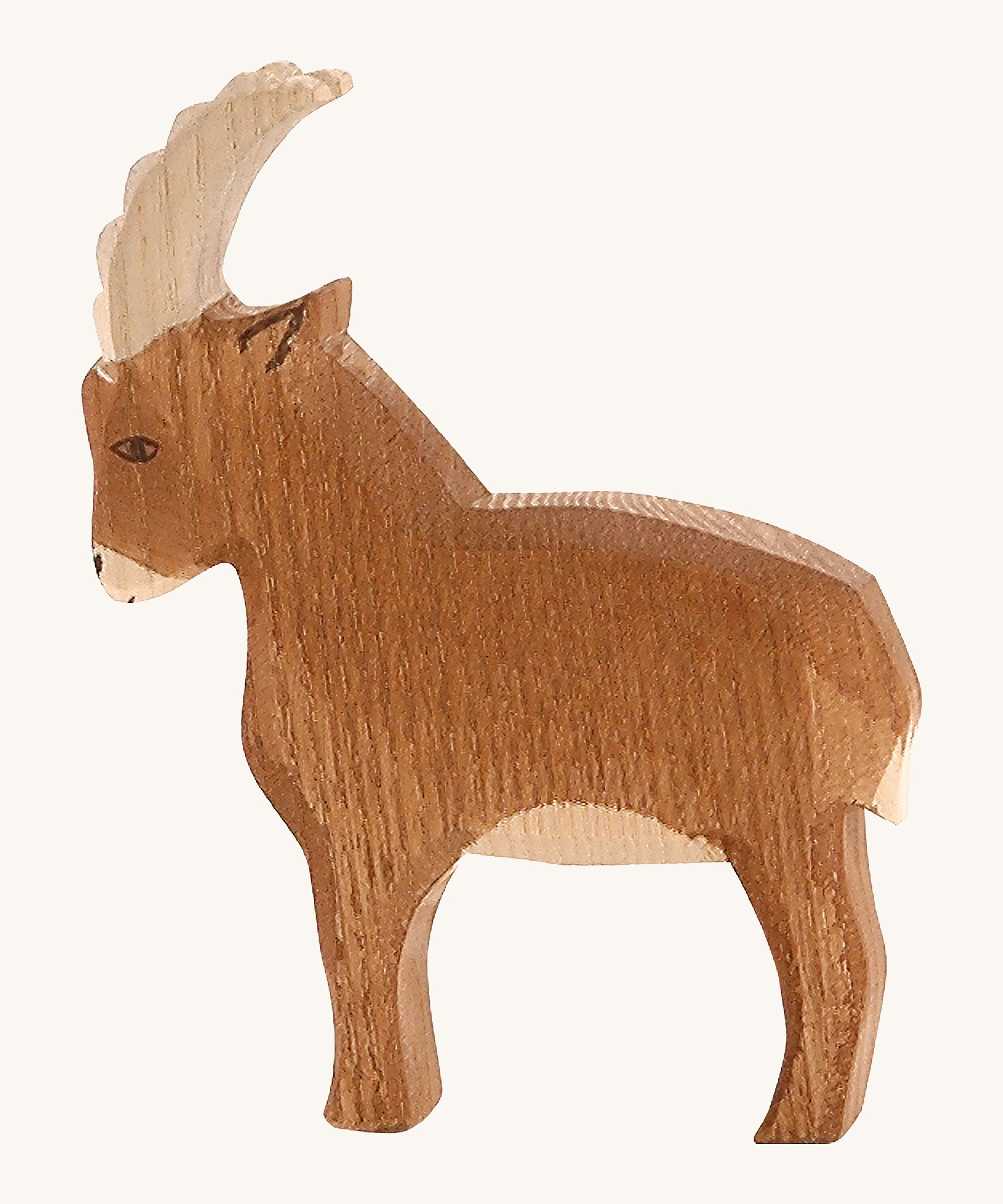 A brown wooden Ostheimer mountain goat on a cream background.