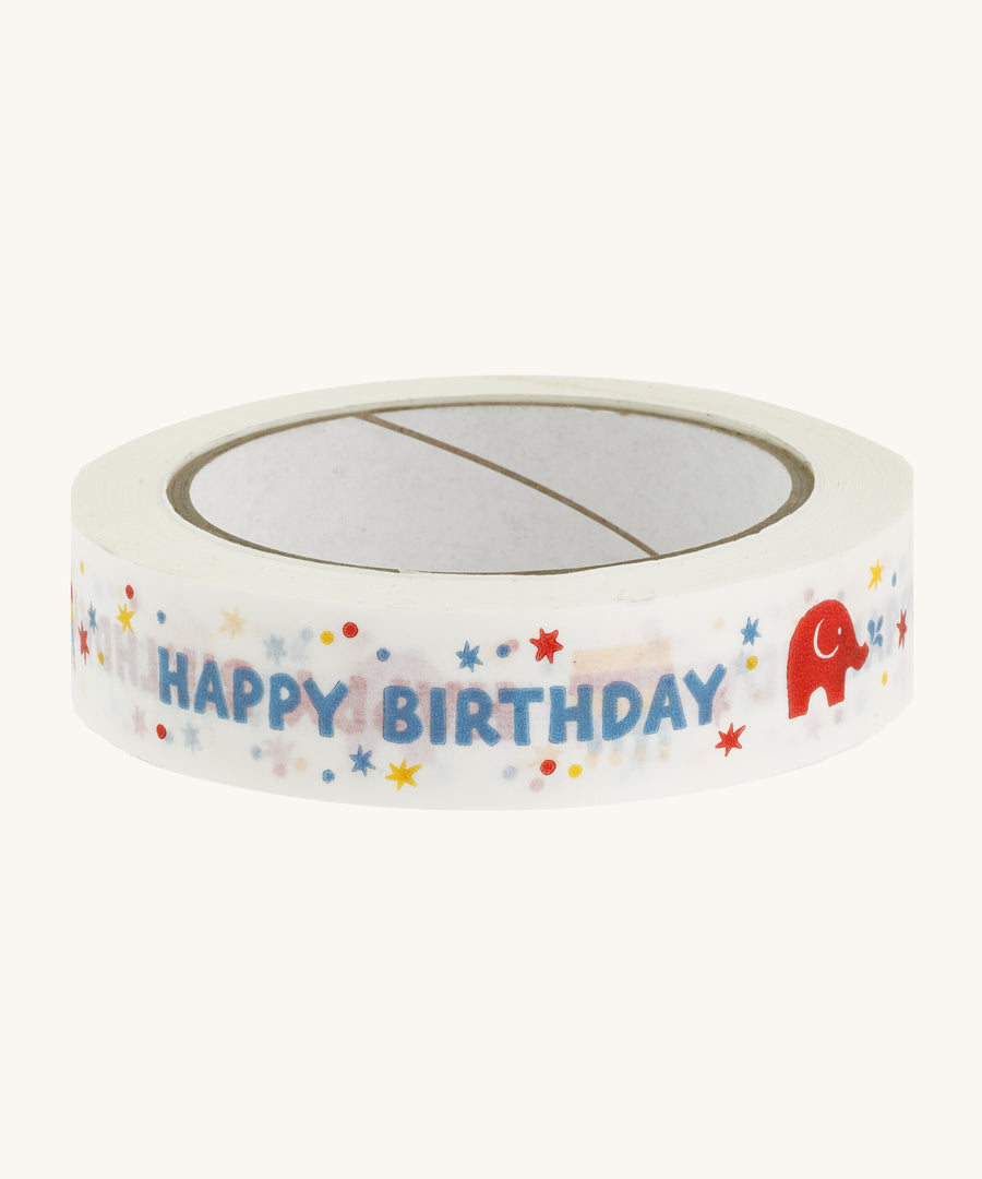 Happy birthday paper tape on a cream background.