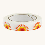 Paper tape with sunshine design on cream background.