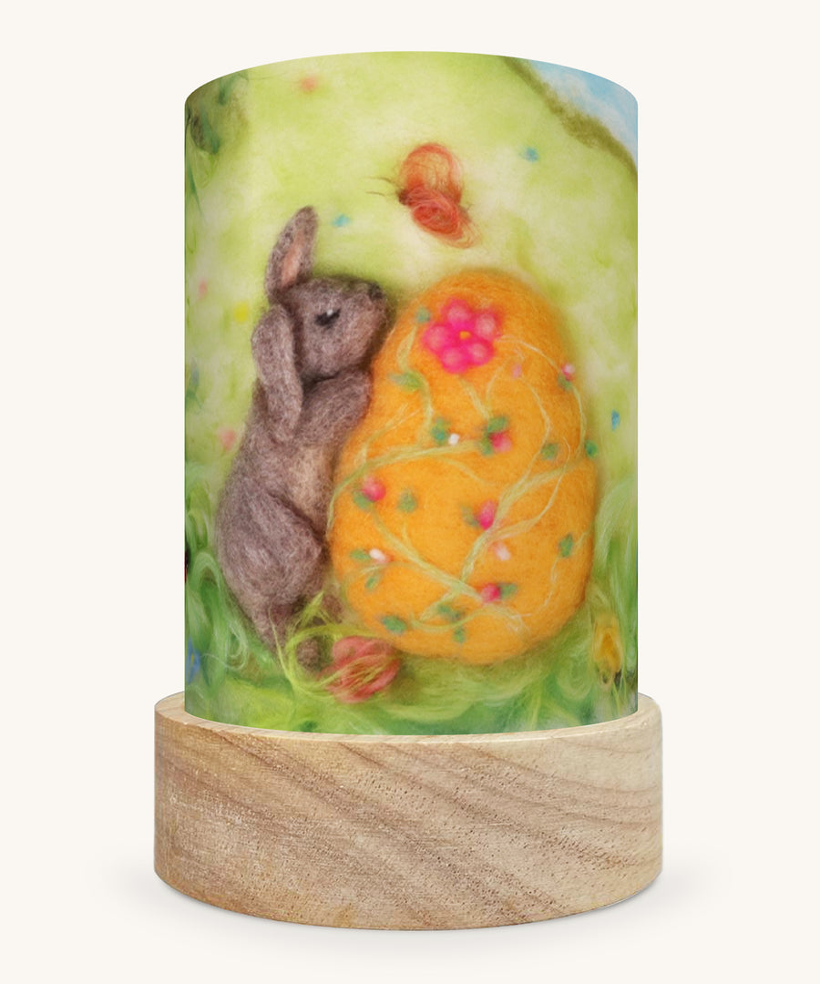 The Pasen Easter illustration by Het Wol Feetje sat in a Toverlux Magic Lantern base, on a cream background