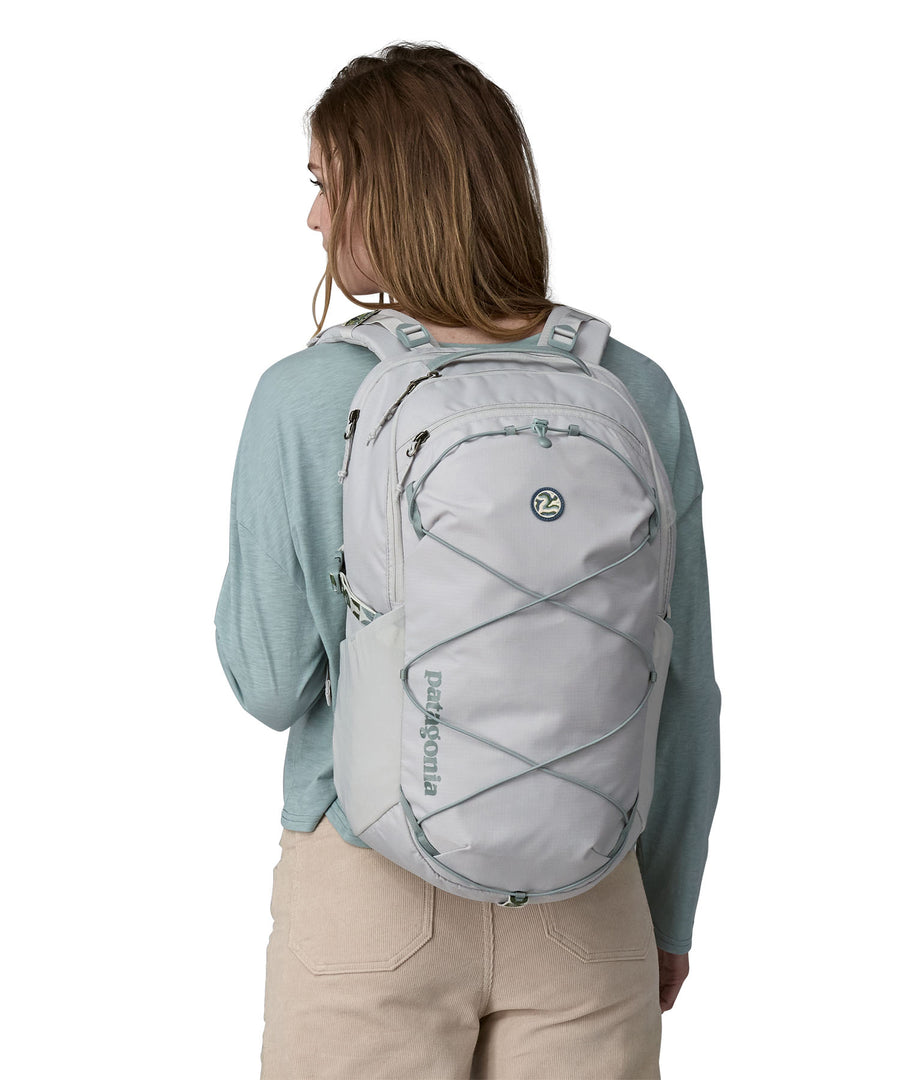 A person wearing the Patagonia Refugio Day Pack 30L Crisp Grey, showing the front of the bag