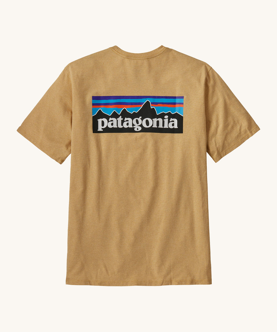 Patagonia Men's P-6 Logo Responsibili-Tee - Beeswax Tan. A dark yellow, short sleeve, organic cotton top with a Patagonia mountain range logo on the back