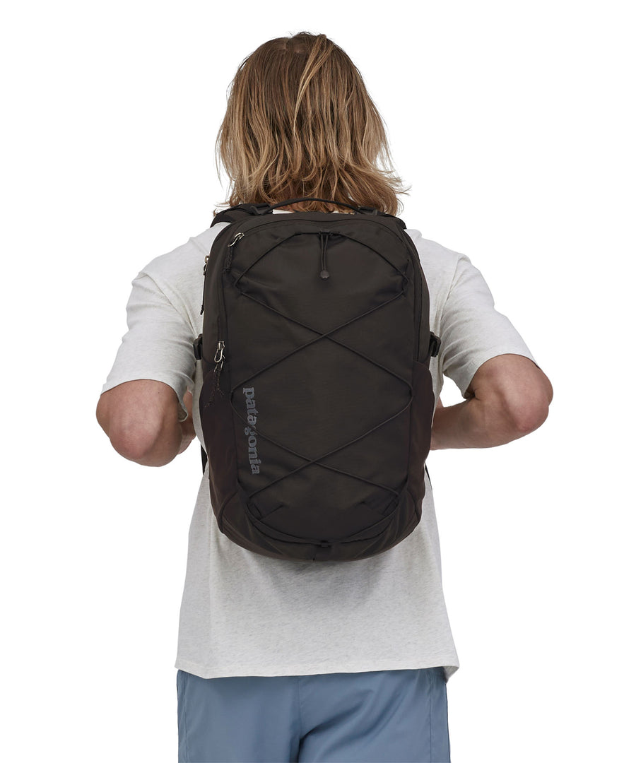 A person wearing the Patagonia Refugio Day Pack 30L Black