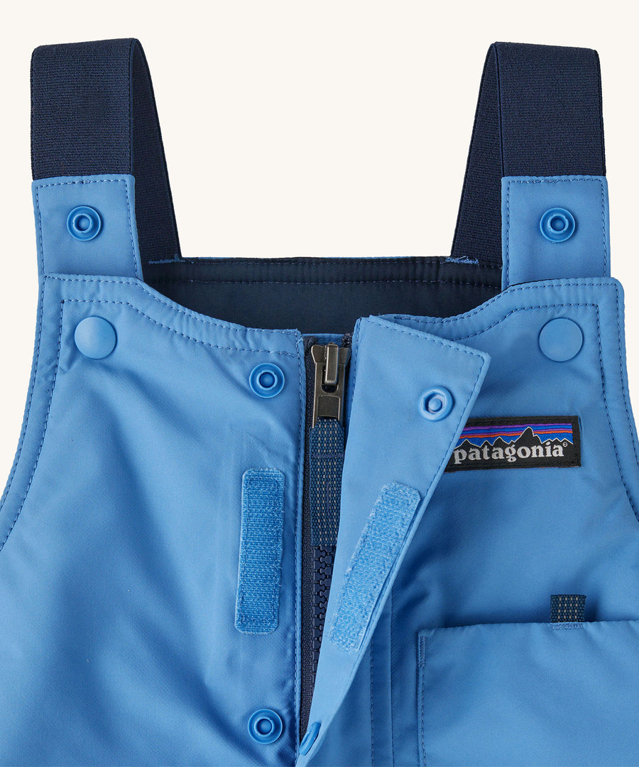 A closer look at the Patagonia Baby Snow Pile Bibs Zip Up Wind flap and shoulder straps