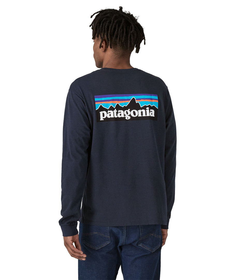 A person showing the fit of the Patagonia L/S P-6 Logo Responsibili-Tee - New Navy from the back