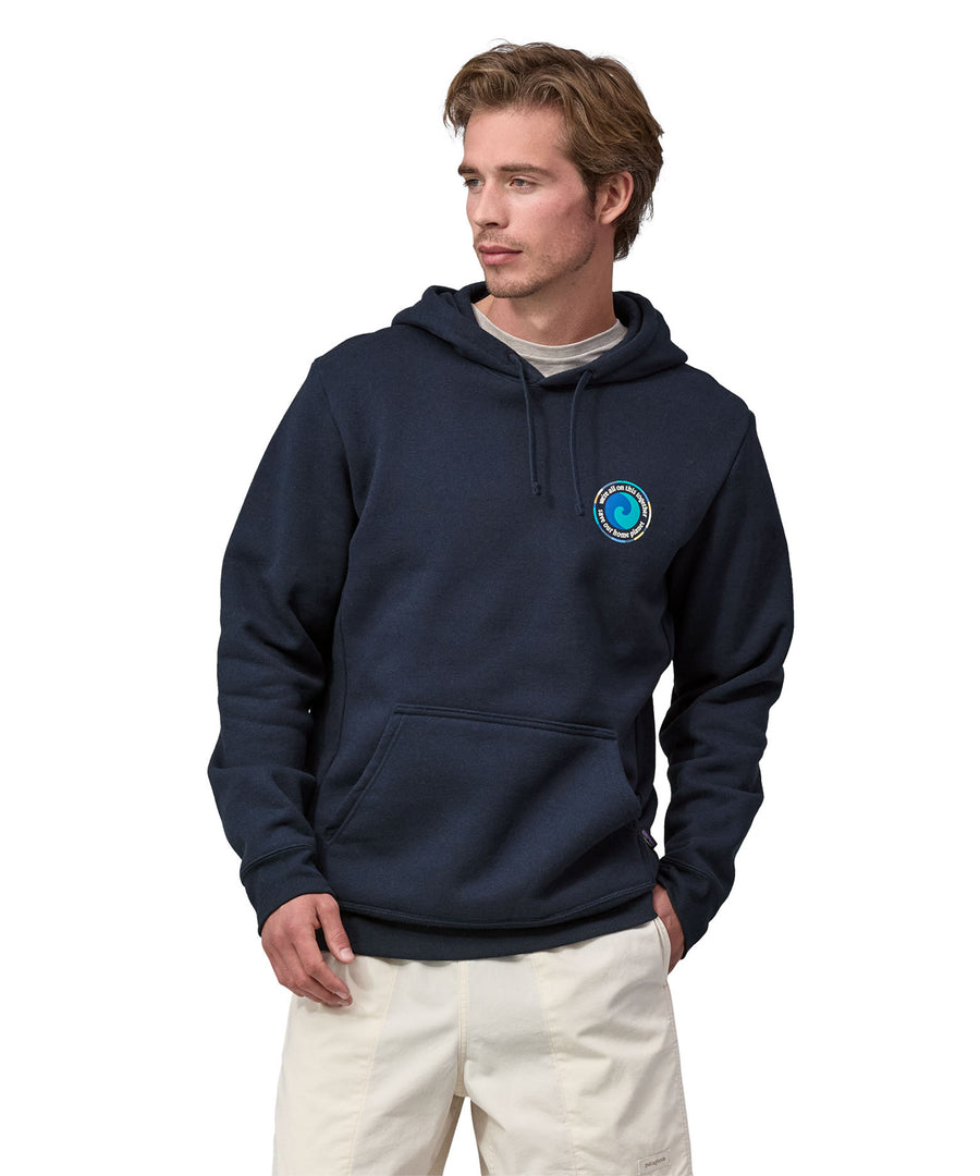 An adult wearing the Patagonia Unity Fitz Uprisal Hoody - New Navy