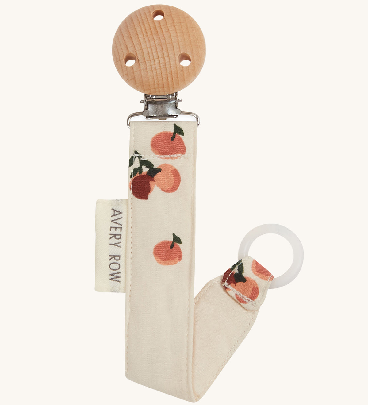 Avery Row Pacifier Holder - Peaches, showing the silicone ring and wooden clip