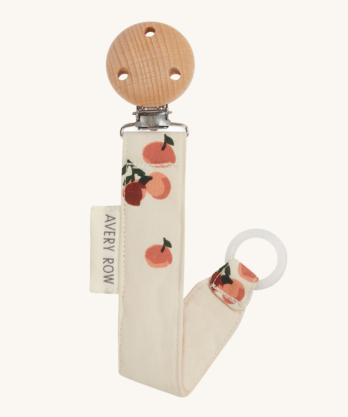 Avery Row Pacifier Holder - Peaches, showing the silicone ring and wooden clip