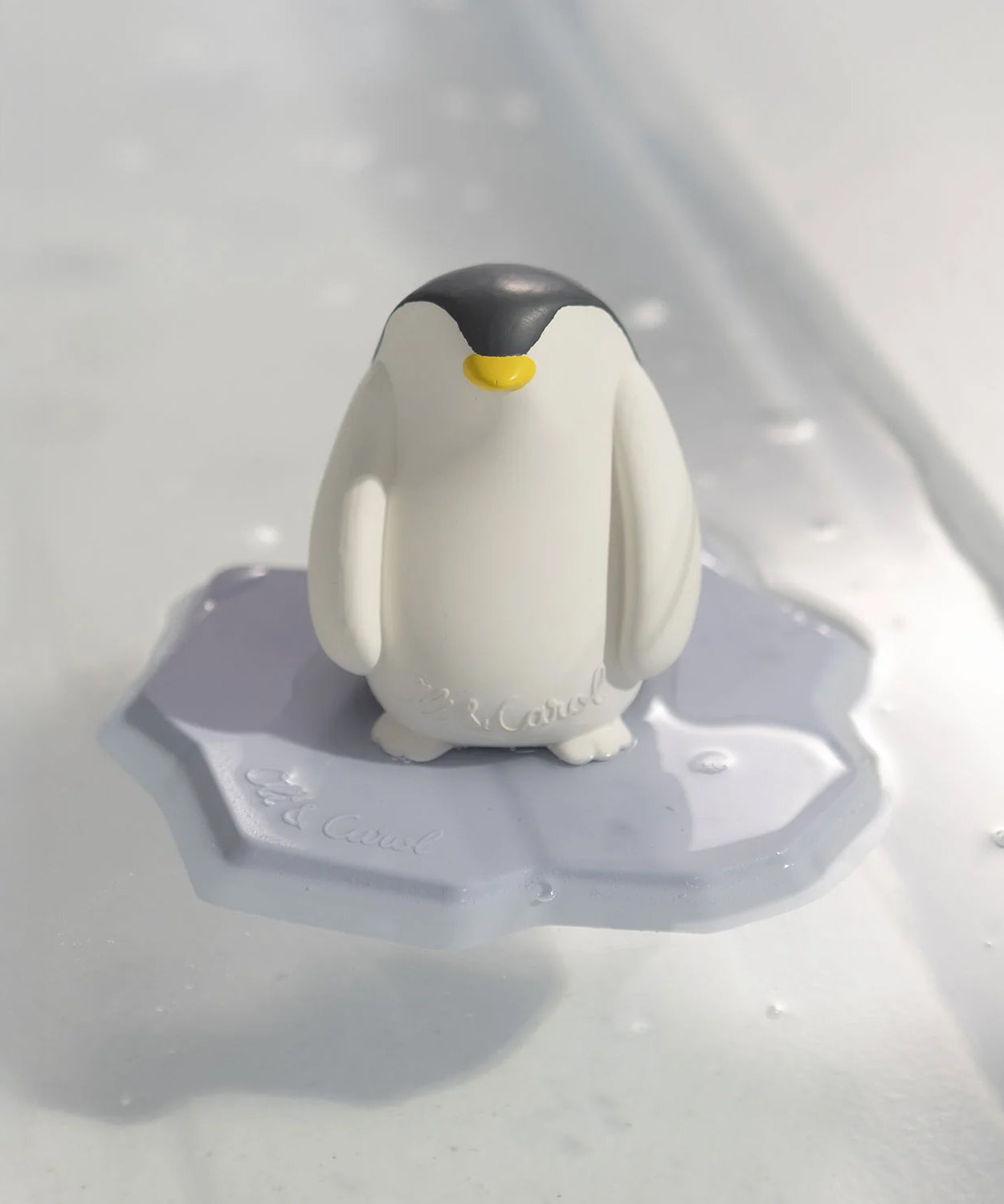 The Oli & Carol Penguin Bath Toy Set made from 100% Natural Rubber, stood on its base, floating on water