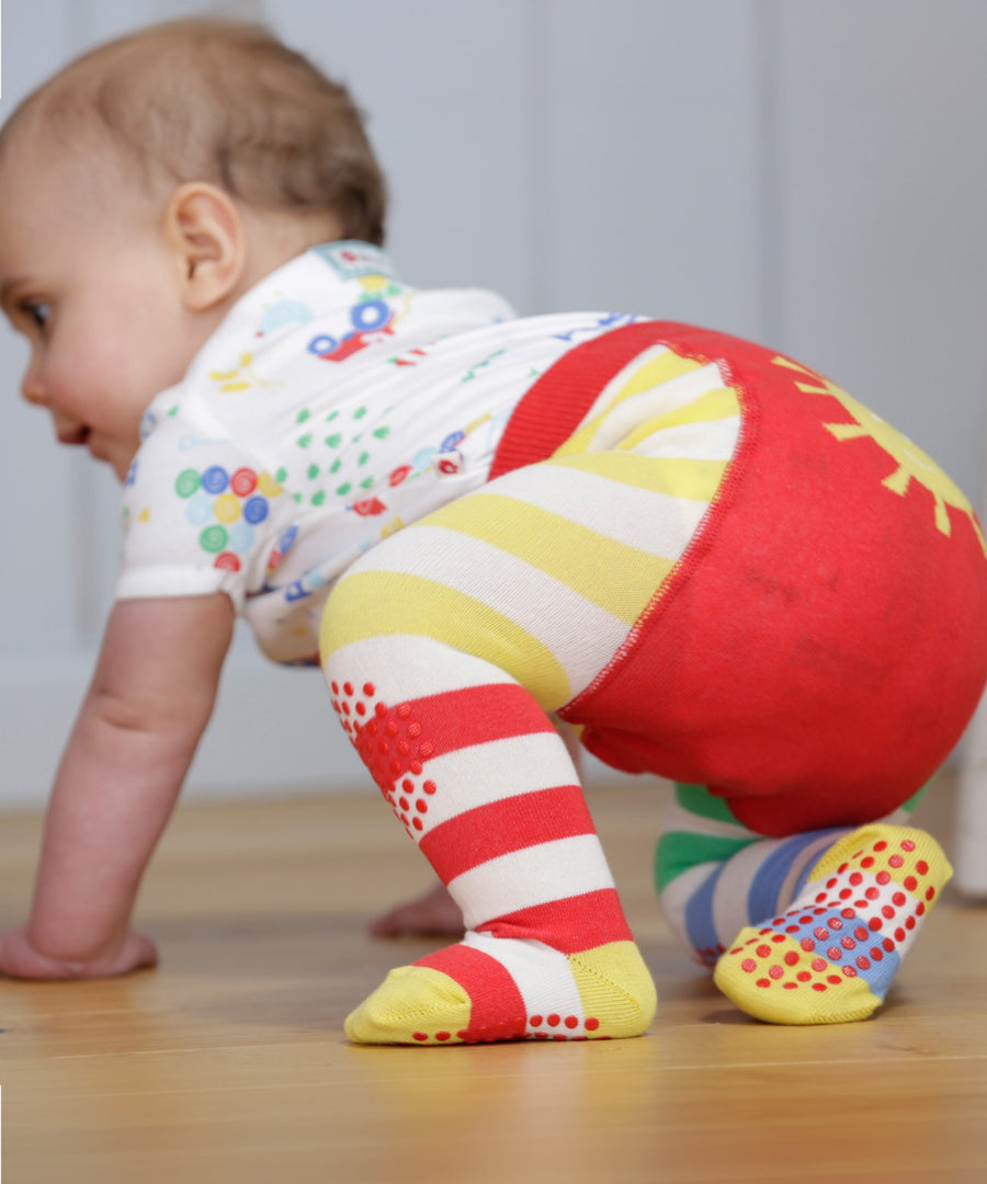 A closer look at the red and yellow stripe, and dot grippers on the Piccalilly Hotchpotch Crawler Tights