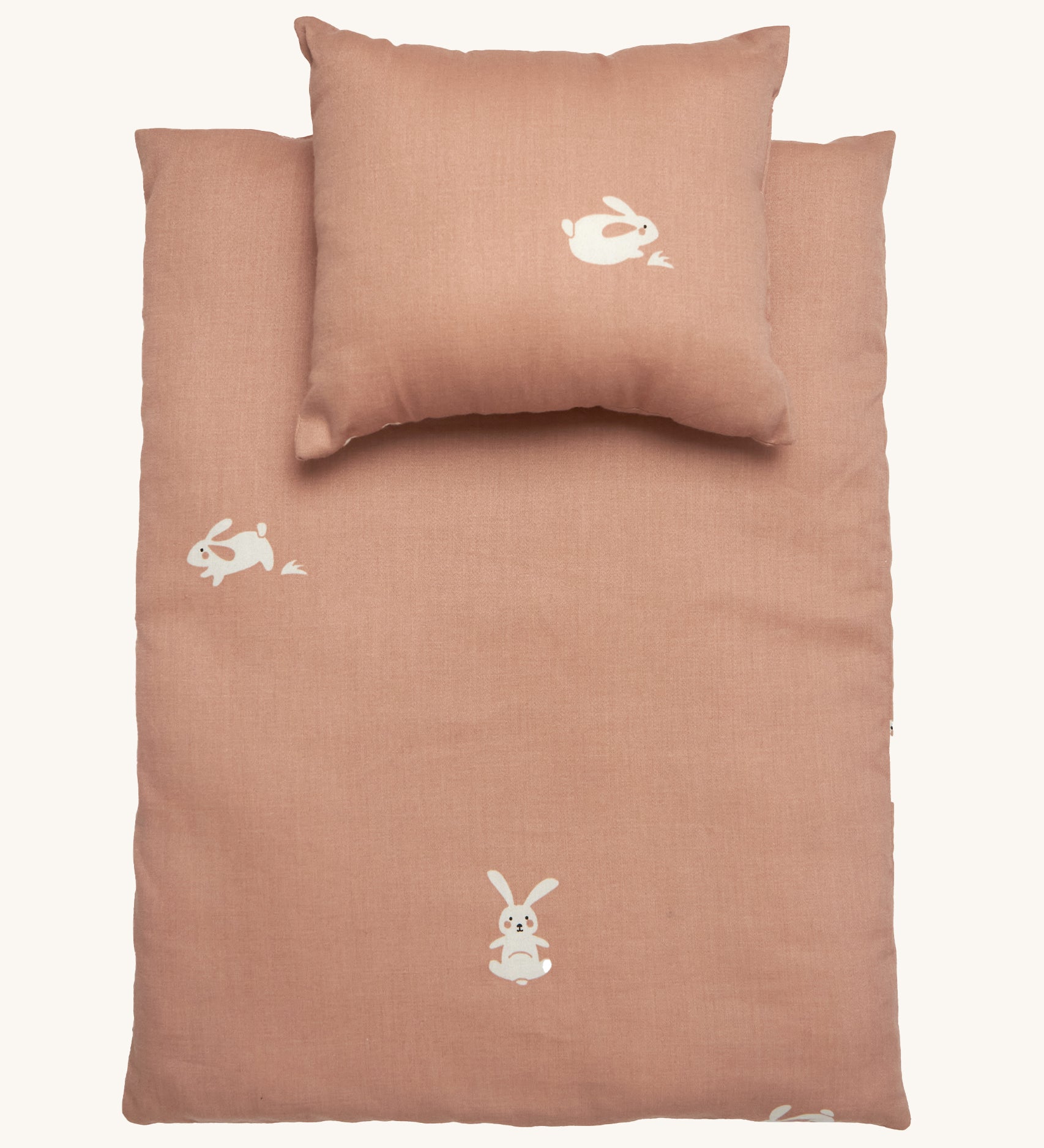 Roommate Doll Bedding Set - Rabbit in a pale pink colour with adorable rabbit print. The image shows a blanket and a pillow, on a cream background