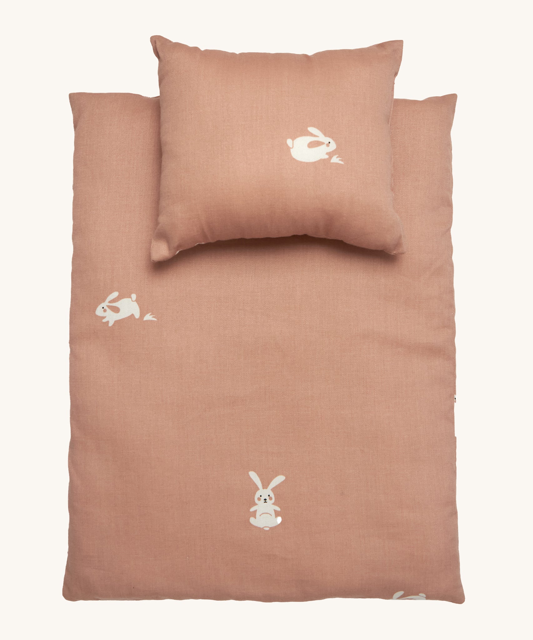 Roommate Doll Bedding Set - Rabbit in a pale pink colour with adorable rabbit print. The image shows a blanket and a pillow, on a cream background