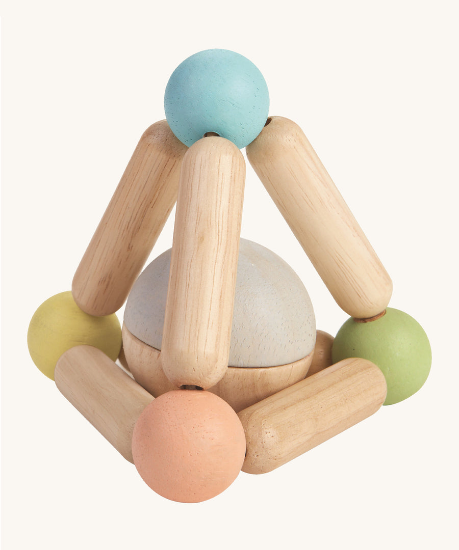 The PlanToys Pastel Triangle Clutching Toy, is a fun and interactive toy for babies and little ones. This sensory toy from PlanToys is made up of a flexible pyramid made up from wooden lengths and painted beads in the colour blue, peach, green and yellow, with a chunky ball inside, which can be removed to be played with separately. The image is on a cream background