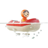 The PlanToys Coast Guard Boat Bath Toy floating on water on a white background