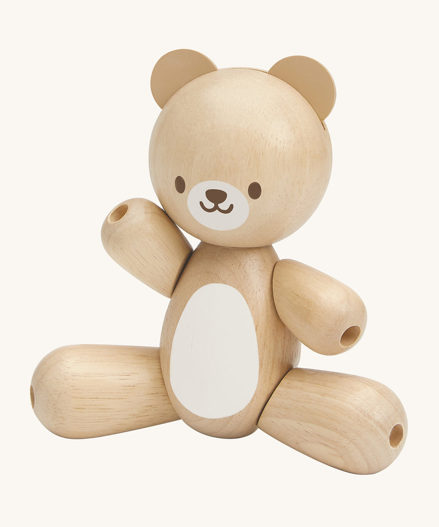 This PlanToys Bear is a sweet wooden toy that will be loved by babies and toddlers. This wooden baby toy bear has legs and arms that move around, a white tummy patch and a happy and smiling face. The image is on a cream background