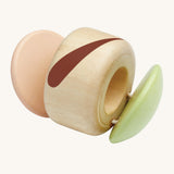 The PlanToys plastic-free, wooden clapping roller toy is a fun, sensory toy for babies and little ones. The clapper sides are in a soft pink and soft green colour, an the middle is natural wood with a brown stripe. The image is on a cream background.