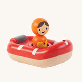 PlanToys Coast Guard Boat Bath Toy and Coastguard figure sat inside the boat, on a cream background