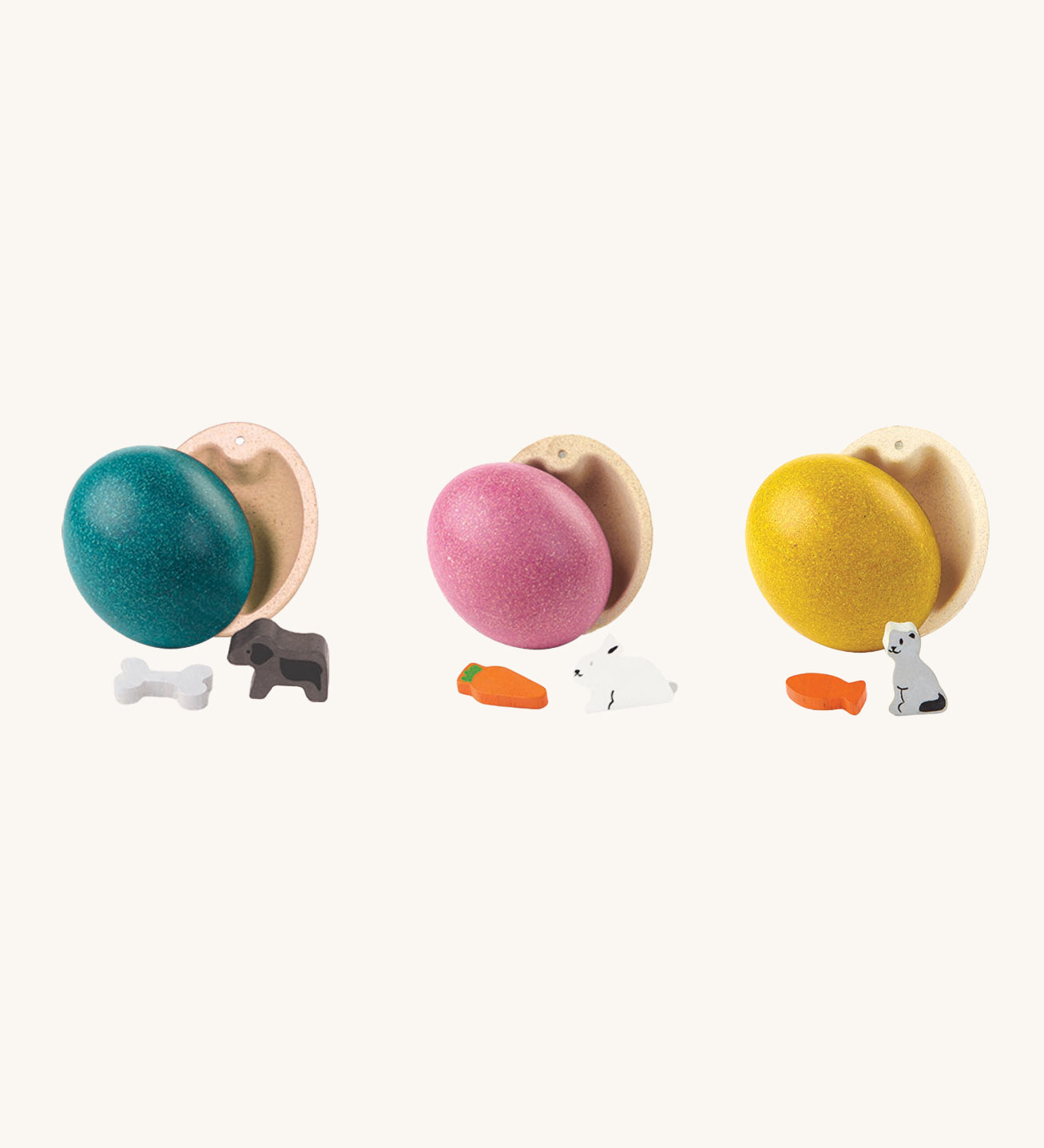 PlanToys Eggs are a fun, plastic-free, Easter egg alternative for little ones. Each egg comes with a little animal figure inside. These are a blue egg with a dog and bone, a pink egg with a rabbit and carrot, and a yellow ess with a cat and a fish. The image is on a cream background